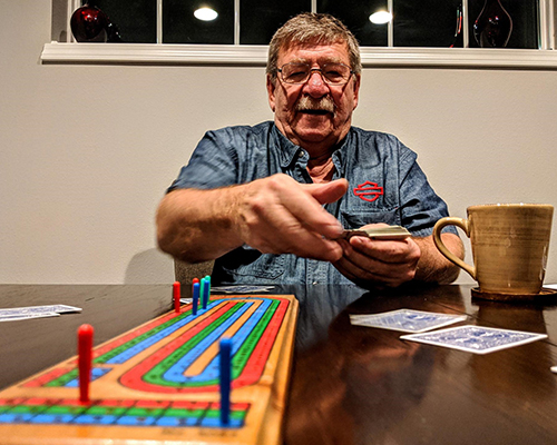 An older Wisconsin gentleman, Dennis Brunner, animatedly playing cribbage. An older Wisconsin gentleman, Dennis Brunner, animatedly playing cribbage.